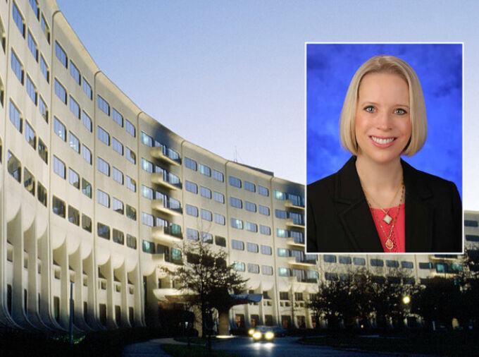 A head and shoulders professional photo of Dr. Jennifer Kraschnewski against a picture of Penn State College of Medicine