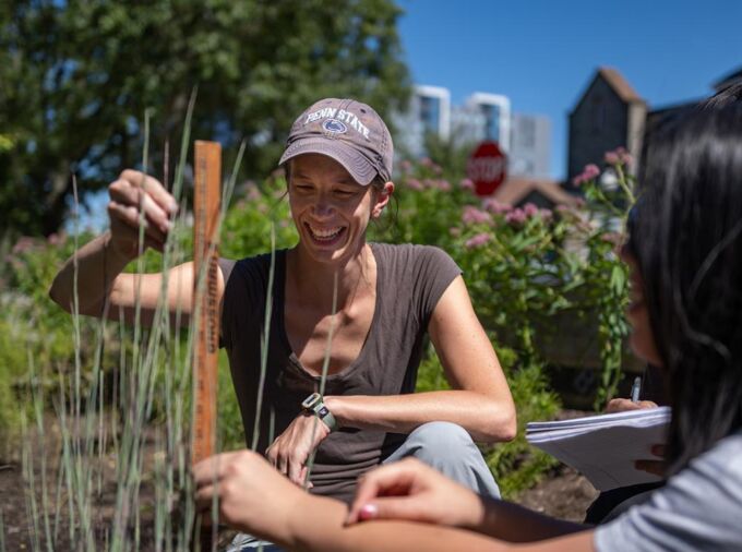 Lauren McPhillips, assistant professor of civil and environmental engineering and of agricultural and biological engineering, and students survey vegetation characteristics of green stormwater infrastructure. These nature-based solutions for stormwater management are becoming more common in cities as they look to address local water quality and quantity issues. Credit: Kelby Hochreiter / Penn State. Creative Commons