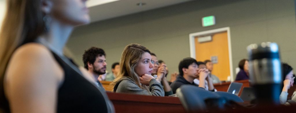 Grad Student listening to a presentation