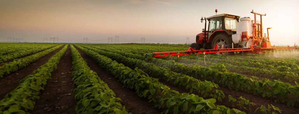 Tractor spraying a field