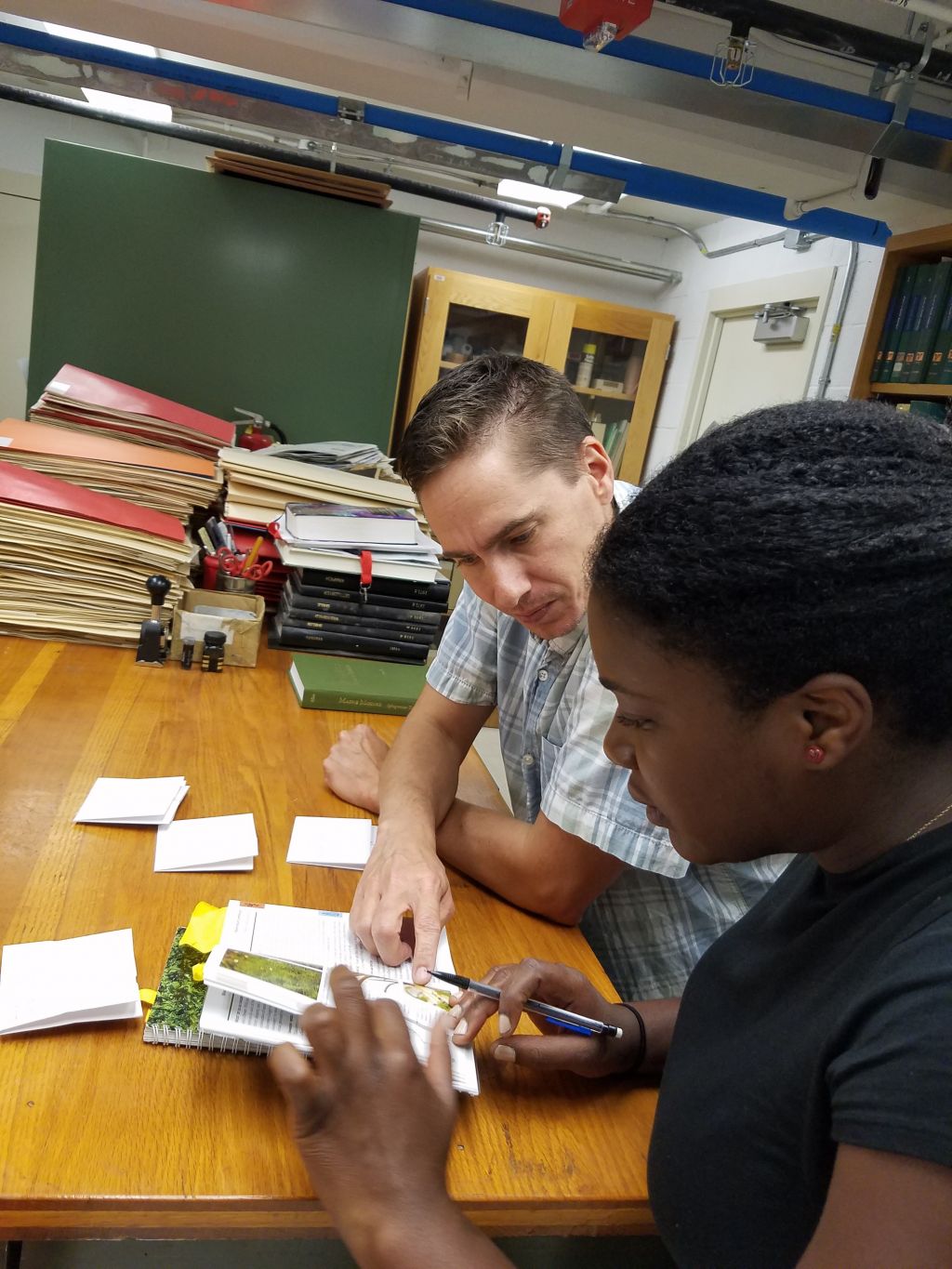 Scott Schutte of the Western Pennsylvania Conservancy assists Penn State graduate student Shauna Rainford with bryophyte identification