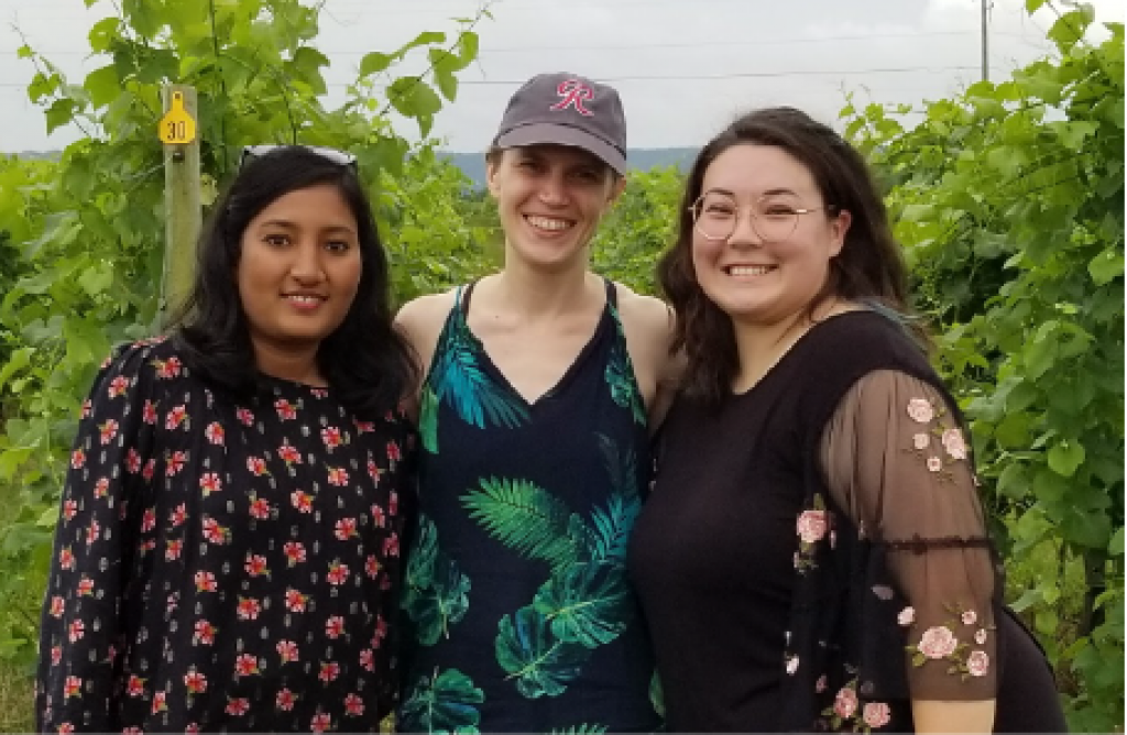 PSU's Natalie Boyle and Jaya Mokkapati in a grape vineyard with a summer undergraduate intern