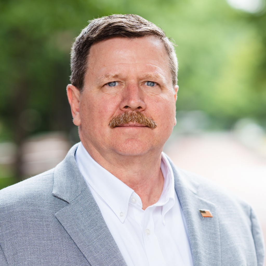 A headshot portrait of Troy Ott