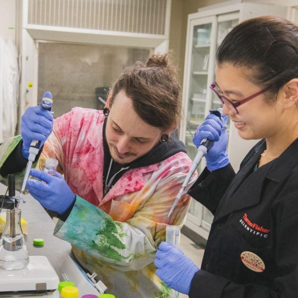 Graduate student Chad Smies and postdoctoral scholar Jiyeon “Joan” Baek manipulate a solution that will be used to visualize protein expression in the mouse brain. Credit: Michelle Bixby / Penn State. Creative Commons