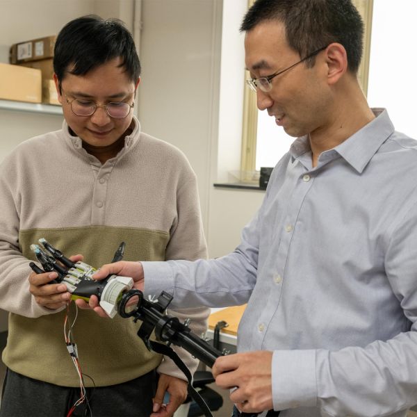 Xiaogang Hu, right, the Dorothy Foehr Huck and J. Lloyd Huck Chair in Neurorehabilitation and associate professor of mechanical engineering, will lead a $4 million grant from the U. S. National Science Foundation to make robotic protheses more useful for people living with amputations. Long Meng, left, a postdoctoral scholar in Hu's lab, will participate in the research. Credit: Kate Myers/Penn State. All Rights Reserved.