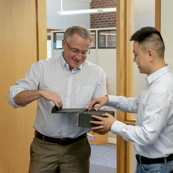 Bruce Chen receives his award from Huck Director Andrew Read