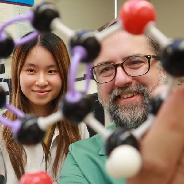 Study first author Yanxin Lin, left, and senior author Misha Kwasniewski examine the structure of the chemical catechin, an important polyphenol and building block of tannins. The new tannin-measurement method breaks large, complex structures into catechin ions and other fragments to characterize the original structure. Credit: Penn State. Creative Commons