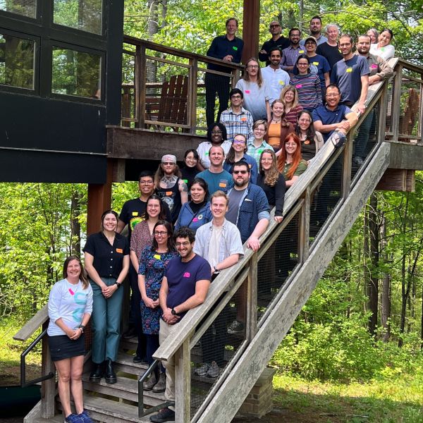 Members of the CRRB standing on an outside staircase to pose for a group photo