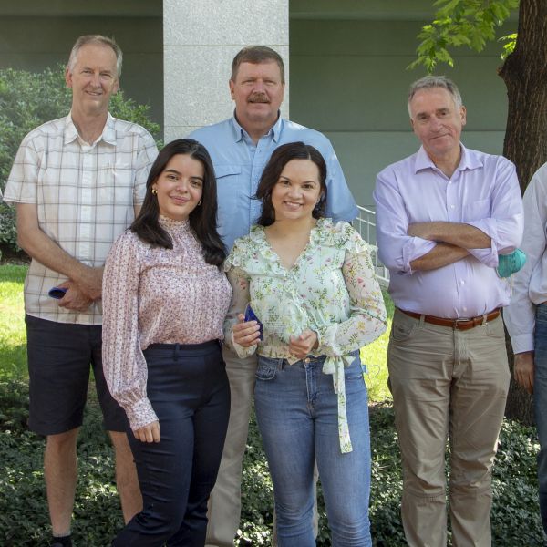 Jim Marden, Troy Ott, Andrew Read, Maria Solares, Isabel da Silva standing outside the Huck Life Sciences Building. Isabel is holding a plaque