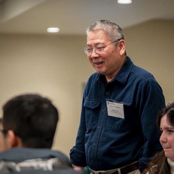 Teh-hui Kao, distinguished professor of biochemistry and molecular biology and chair of the plant biology intercollege graduate degree program, speaks with prospective students at a recruiting event on Jan. 19, 2024. Credit: Keith Hickey / Penn State. Creative Commons