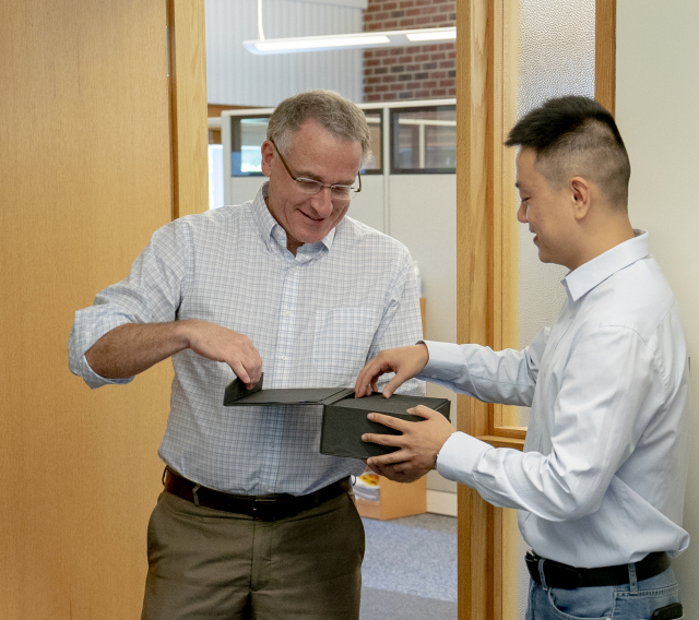 Bruce Chen receives his award from Huck Director Andrew Read