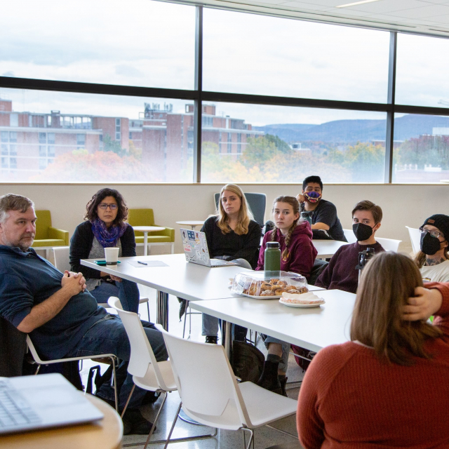 People at a TaMIS meeting, seated around a table