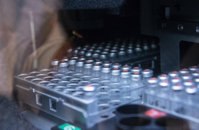 In the Metabolomics Core Facility, vials filled with extracts of bodily fluid wait in an auto-sampler. Each sample will be passed through a chromatography system that sorts the complex sample into its constituents. Droplets of the separated sample are then misted into the mass spectrometer for analysis.IMAGE: PATRICK MANSELL