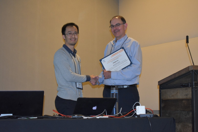 Meeting co-organizer and BMB Professor Joe Reese presents Feiyue Lu with the BBA-Gene Regulatory Mechanisms Poster Award