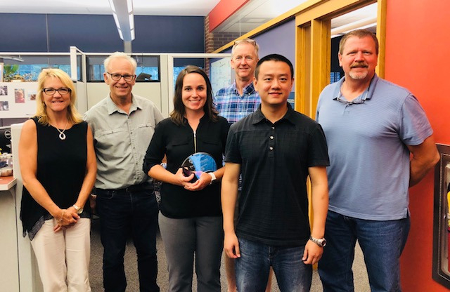 Five members of the Huck Graduate Student Advisory Committee pose to celebrate outgoing graduate adviser, Kelly Ness